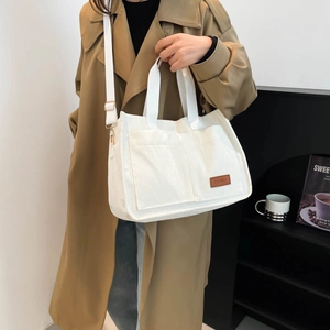 Minimalist white corduroy tote bag with adjustable strap and large pockets for women