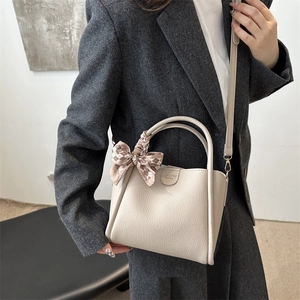 Chic beige bucket bag with lychee texture and plaid ribbon handle for women