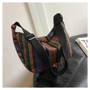 Detail of bohemian canvas crossbody bag with ethnic patterns and adjustable strap