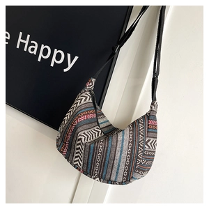 Detail view of Bohemian woven tote with colorful stripes and adjustable black shoulder strap