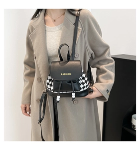 Detail of vintage plaid mini backpack with black PU leather and yellow fashion print
