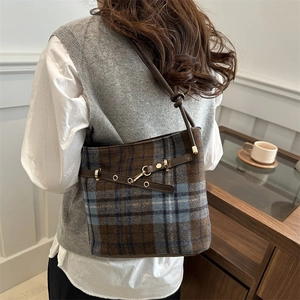 Vintage checkered plaid bucket bag with brown leather trim and metallic hardware accents