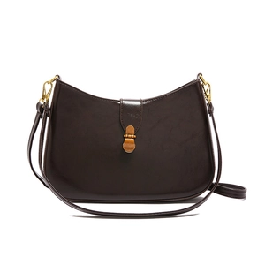 Vintage dark brown semi-circle shoulder bag with antique gold metal lock on white background