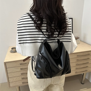 Minimalist black leather backpack for women with adjustable straps and side zipper
