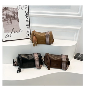 Detailed display of vintage pillow crossbody bags in khaki, black, and brown with woven straps