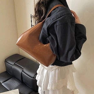 Chic brown crescent underarm bag in smooth faux leather with retro minimalist design