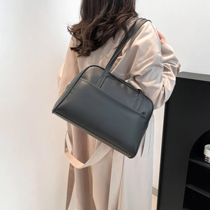 Minimalist black PU leather tote bag shown on model for daily commuting use