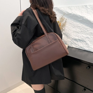 Minimalist large capacity dark brown leather tote bag for women showing back view carry style