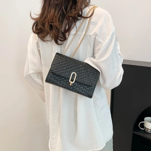 Classic black woven shoulder bag with gold chain strap and elegant metallic twist lock