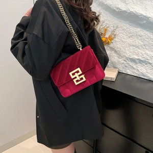 Fashionable red velvet crossbody bag with quilted texture and gold chain strap for women