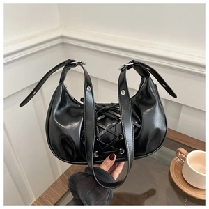 Close-up of black crescent moon bag with lace-up ribbon design and silver metal eyelets
