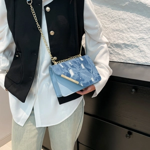 Blue denim and leather crossbody small square bag with distressed details and gold chain strap