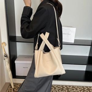 Cream minimalist bucket bag with FASHION lettering and adjustable shoulder strap