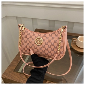 Detailed macro view of pink monogram hobo bag with gold M logo and chain strap