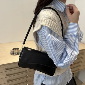 Classic black leather baguette underarm bag with gold buckle and adjustable strap for women