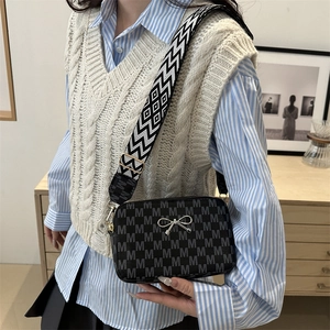 Fashionable black crossbody bag with letter M patterns and wide geometric woven strap