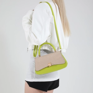 Chic green leather saddle bag with woven panel shown on a model for daily styling