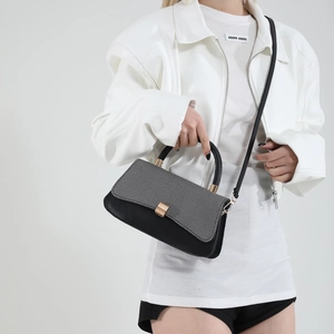 Chic saddle shoulder bag with black leather and grey tweed texture for stylish women