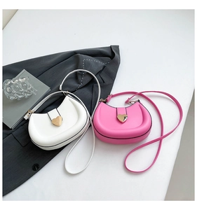 Close-up of crescent bags with gold heart buckles in white and rose pink colors