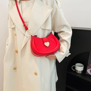 Fashionable red semi-circular crossbody bag featuring a large silver heart-shaped metal lock