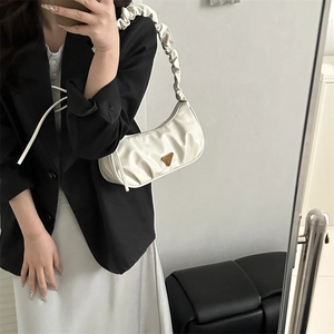 Chic cream ruched cloud bag with gold triangle logo and drawstring strap for women