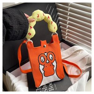 Detail of orange knitted phone bag with cartoon goose pattern and yellow padded handle