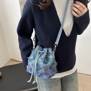 Fashionable denim bucket bag with colorful star patterns and frayed edges for women