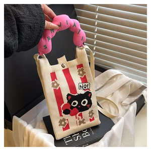 Detail of knitted phone bag with cartoon black cat pattern and pink wavy handle