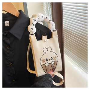 Detail of canvas mini phone bag with cute rabbit cupcake embroidery and puffy handle