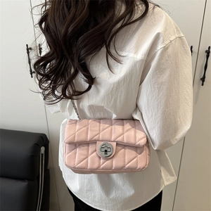 Pink quilted leather crossbody bag with silver chain strap shown worn by a model