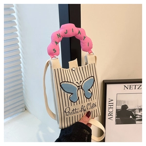 Detail of knit crossbody phone bag featuring blue butterfly embroidery and pink padded handle