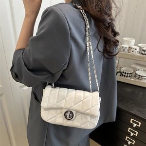 Elegant white quilted chain bag with silver lock, minimalist crossbody style for women