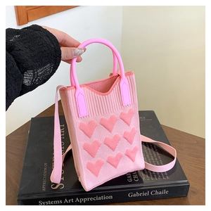 Detailed knit texture of pink heart-pattern crossbody phone bag with round handle