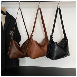 Detailed close-up of retro HOBO tote bags in dark brown, caramel brown, and classic black