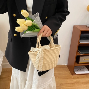 Sac fourre-tout en paille tressée beige avec nœud en dentelle blanche et structure spacieuse