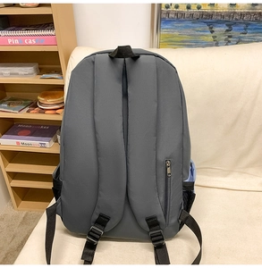 Detail view of the backpack back featuring wide shoulder straps and a hidden anti-theft pocket