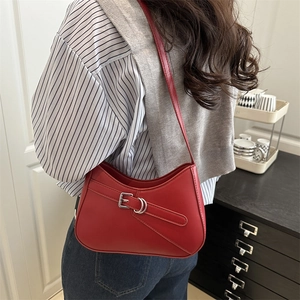 Elegant red crescent shoulder bag in matte leather featuring a decorative metal buckle