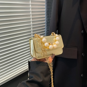 Gold mini chain crossbody bag with crocodile pattern and decorative pearl handle