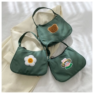 Three green nylon hobo bags featuring cute bear and floral embroidery on textured fabric