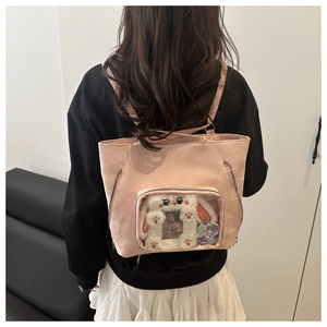 Pink faux leather ita bag with clear window showing plush rabbit and anime charms