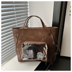 Close-up of brown faux leather itabag with transparent window for anime badges