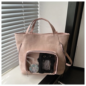Close-up of pink faux suede ita bag with a clear PVC window and zipper side detail
