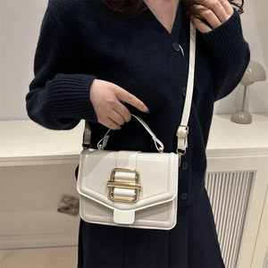 Glossy white minimalist top-handle crossbody bag with a large gold buckle detail