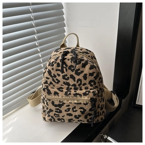Detailed macro view of retro leopard print corduroy texture on a stylish mini backpack