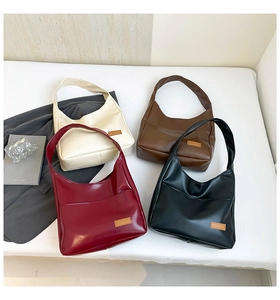 Flat lay of four minimalist tote bags in cream, brown, burgundy, and black PU leather