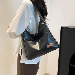 Classic black PU leather hobo tote bag for women with vintage brown logo patch detail
