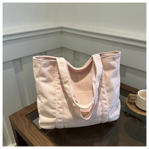 Pink corduroy tote bag with large capacity and soft ribbed texture for daily commuting