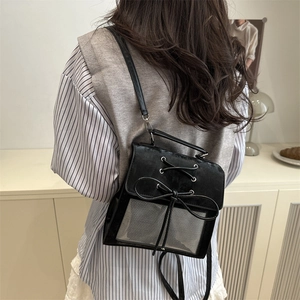 Japanese style black leather ita bag with bow and clear window shown on model