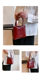 Détail d'un sac cabas bordeaux avec logo blanc et longues anses pour un look élégant