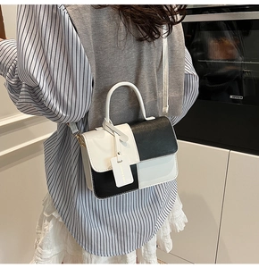 Model wearing a contrasting black and white patchwork leather crossbody square handbag